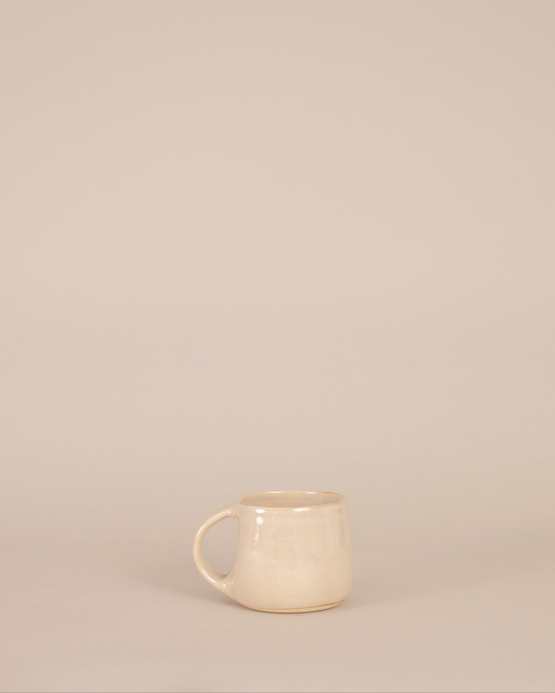 Beige ceramic mug on a beige background