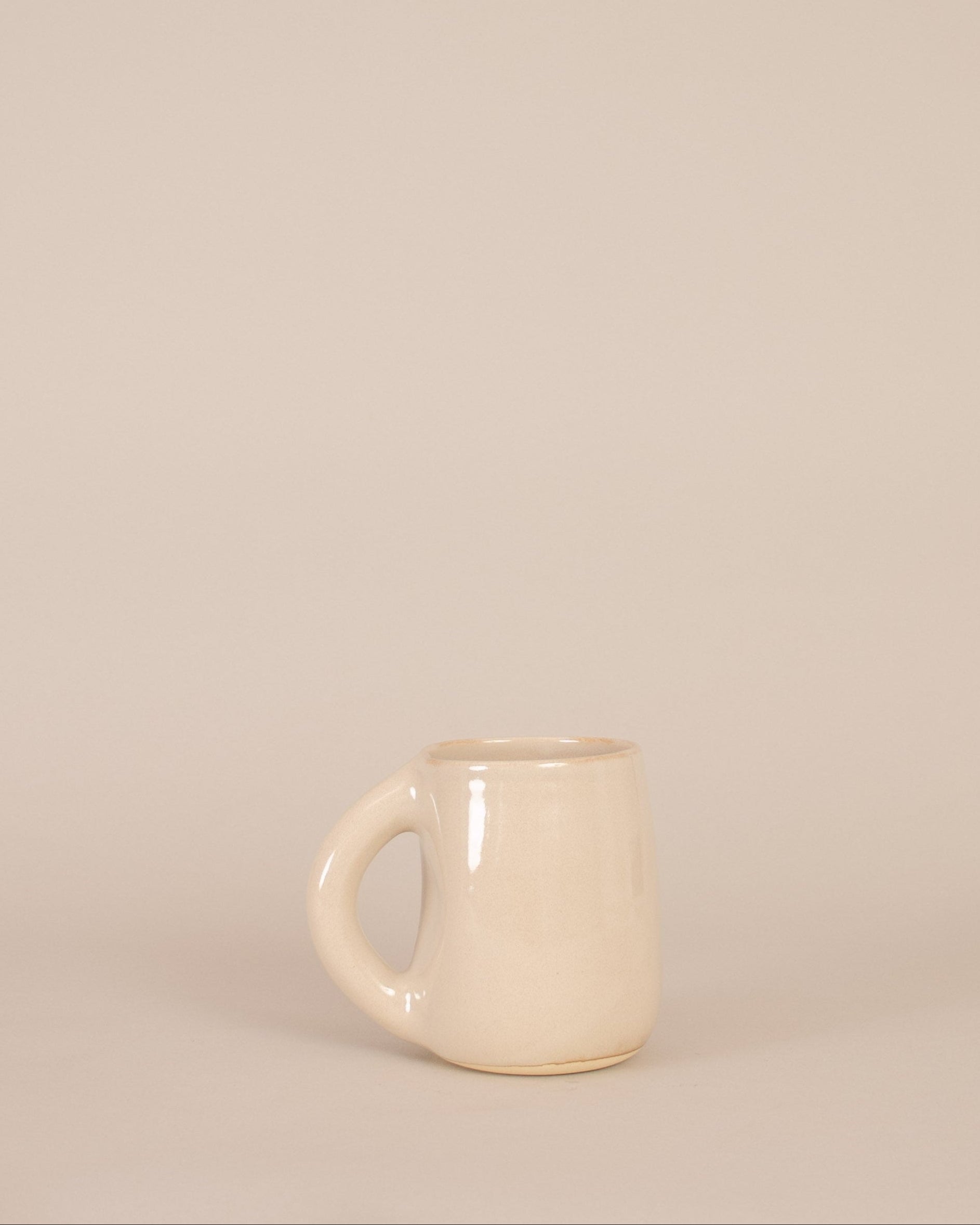 White ceramic mug on a beige background